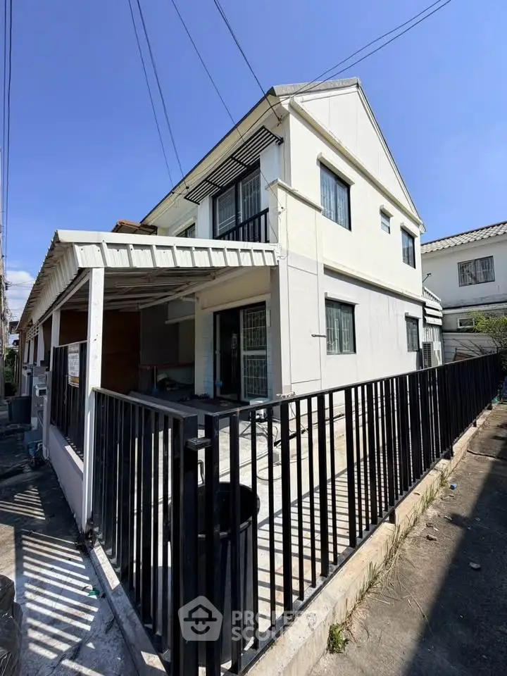 Charming two-story house with fenced yard and modern exterior design.
