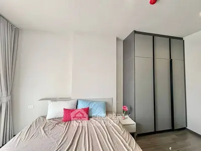 Modern bedroom with sleek wardrobe and cozy bed in stylish apartment.