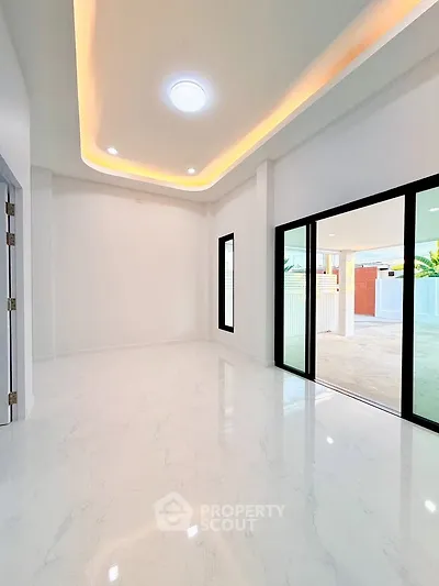 Spacious modern interior with elegant lighting and sliding glass doors