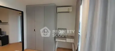 Modern bedroom with sleek wardrobe and compact study desk, perfect for urban living.