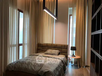 Luxurious bedroom with modern lighting and floor-to-ceiling windows in a high-end apartment.
