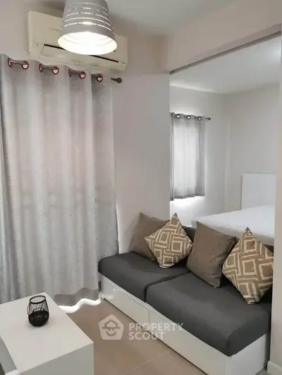 Cozy modern living room with stylish gray sofa and elegant curtains, perfect for urban living.