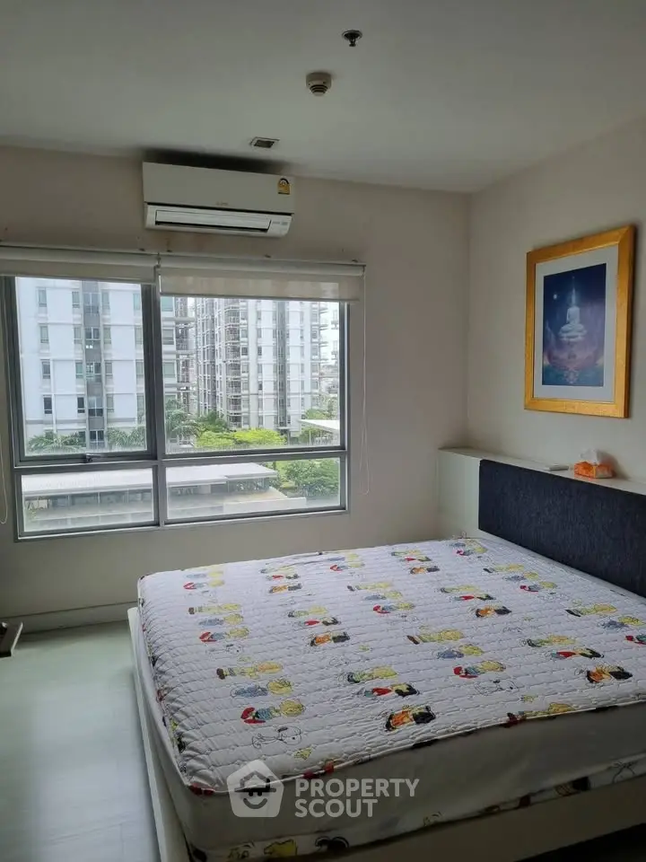 Bright bedroom with large windows and air conditioning in modern apartment.