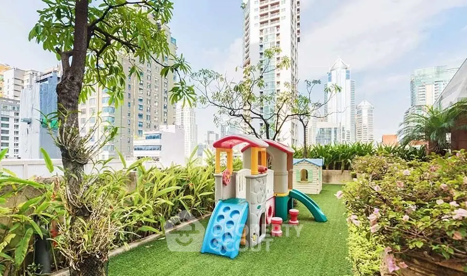 Charming rooftop garden with play area and stunning city views, perfect for family relaxation and entertainment.