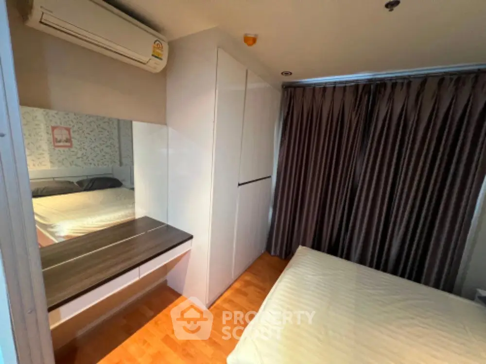 Cozy bedroom with modern decor, featuring a large wardrobe and elegant curtains.