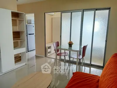 Modern living room with sliding glass doors and cozy furniture in a stylish apartment.