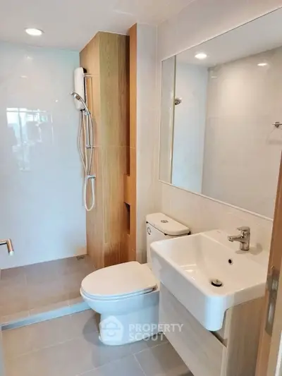 Modern bathroom with sleek fixtures and wood accents
