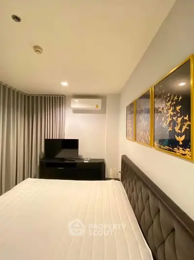 Modern bedroom with stylish decor and air conditioning in a cozy apartment.