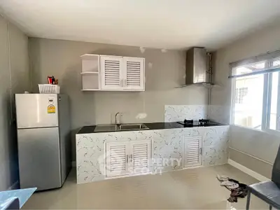 Modern kitchen with sleek cabinets and gas stove, perfect for culinary enthusiasts.