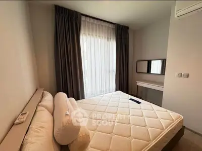 Cozy bedroom with natural light, modern furnishings, and air conditioning for ultimate comfort.