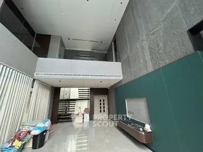Spacious modern living room with high ceiling and sleek design