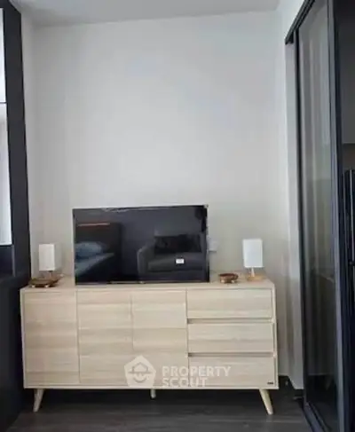 Modern living room with sleek TV stand and flat-screen TV, perfect for contemporary urban living.