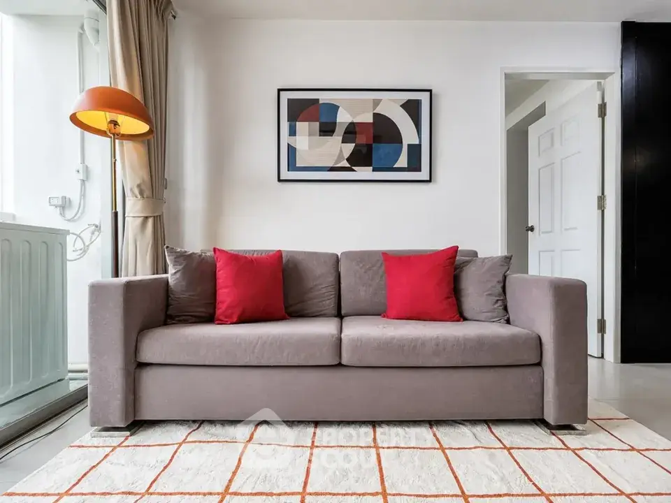 Modern living room with stylish sofa and abstract art, perfect for contemporary urban living.