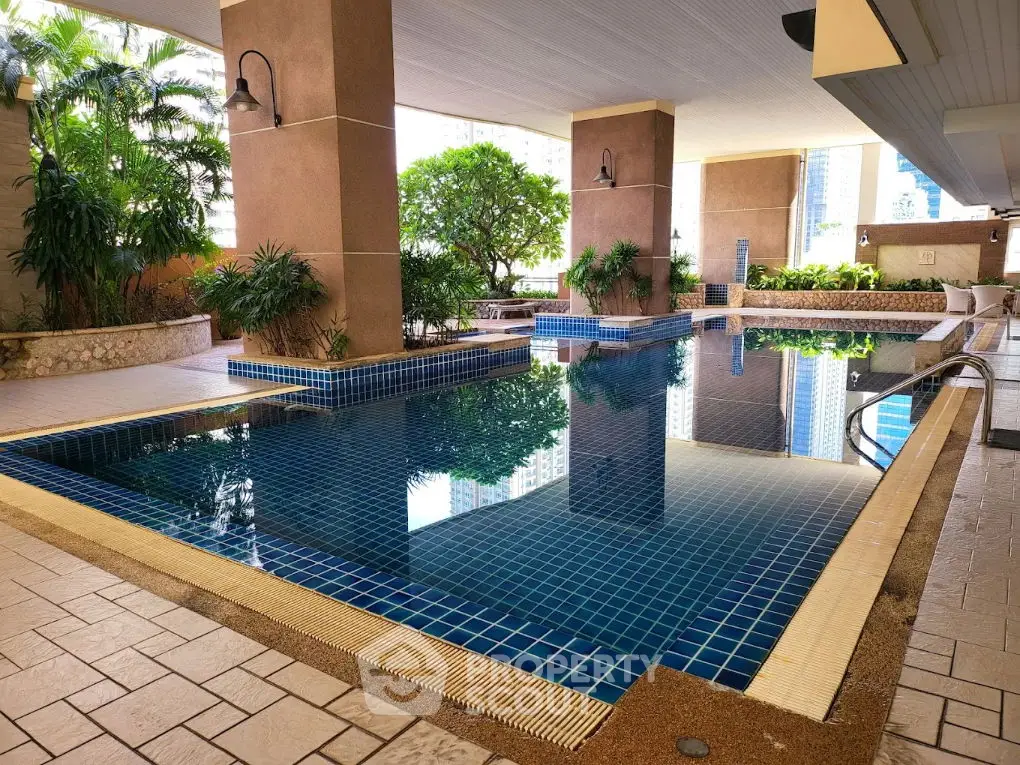 Luxurious indoor pool area with lush greenery and modern design