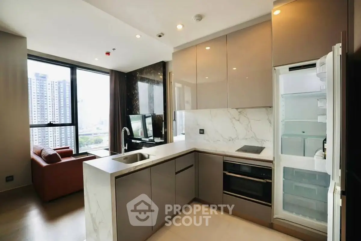 Modern open-layout kitchen with sleek appliances and city view