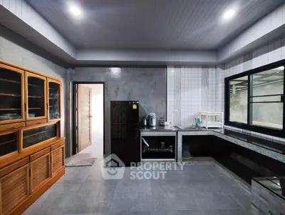 Spacious modern kitchen with sleek appliances and ample storage in a contemporary home.