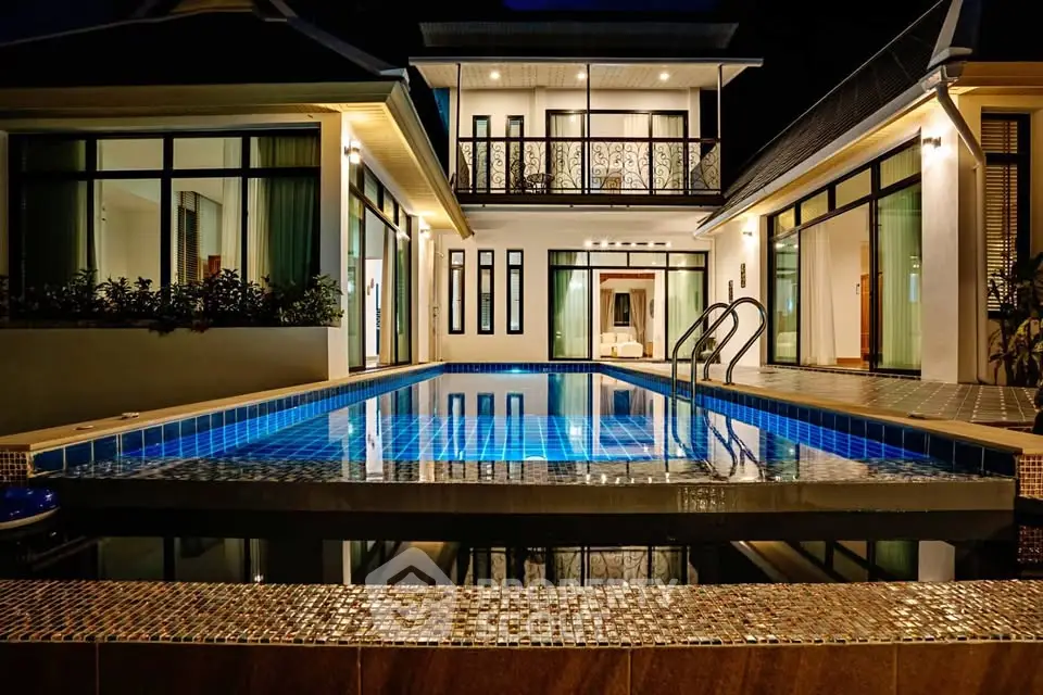 Luxurious modern villa with illuminated pool and elegant architecture, perfect for upscale living.