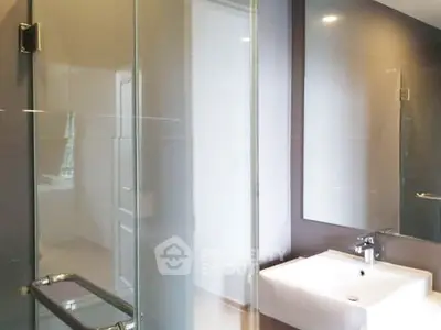 Modern bathroom with glass shower and sleek sink design