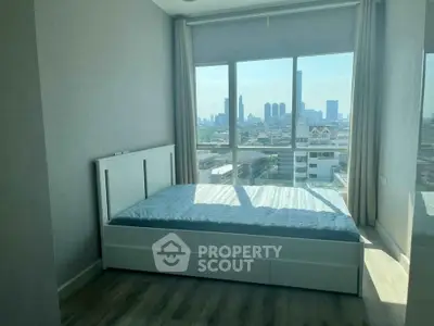 Modern bedroom with city view and large windows in a high-rise apartment.