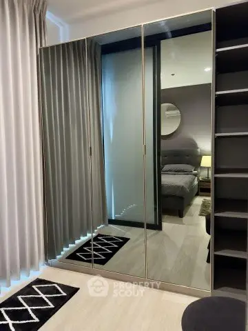 Modern bedroom with mirrored wardrobe and stylish decor