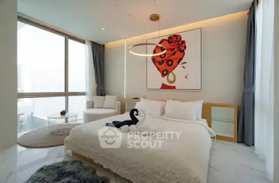 Luxurious modern bedroom with elegant decor and large windows offering natural light.