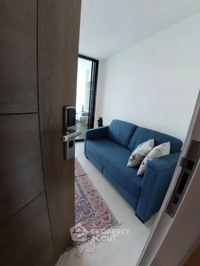 Cozy living room with blue sofa and elegant rug, perfect for relaxation.