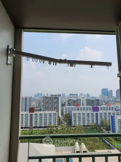 Stunning urban view from a high-rise balcony with modern cityscape backdrop.