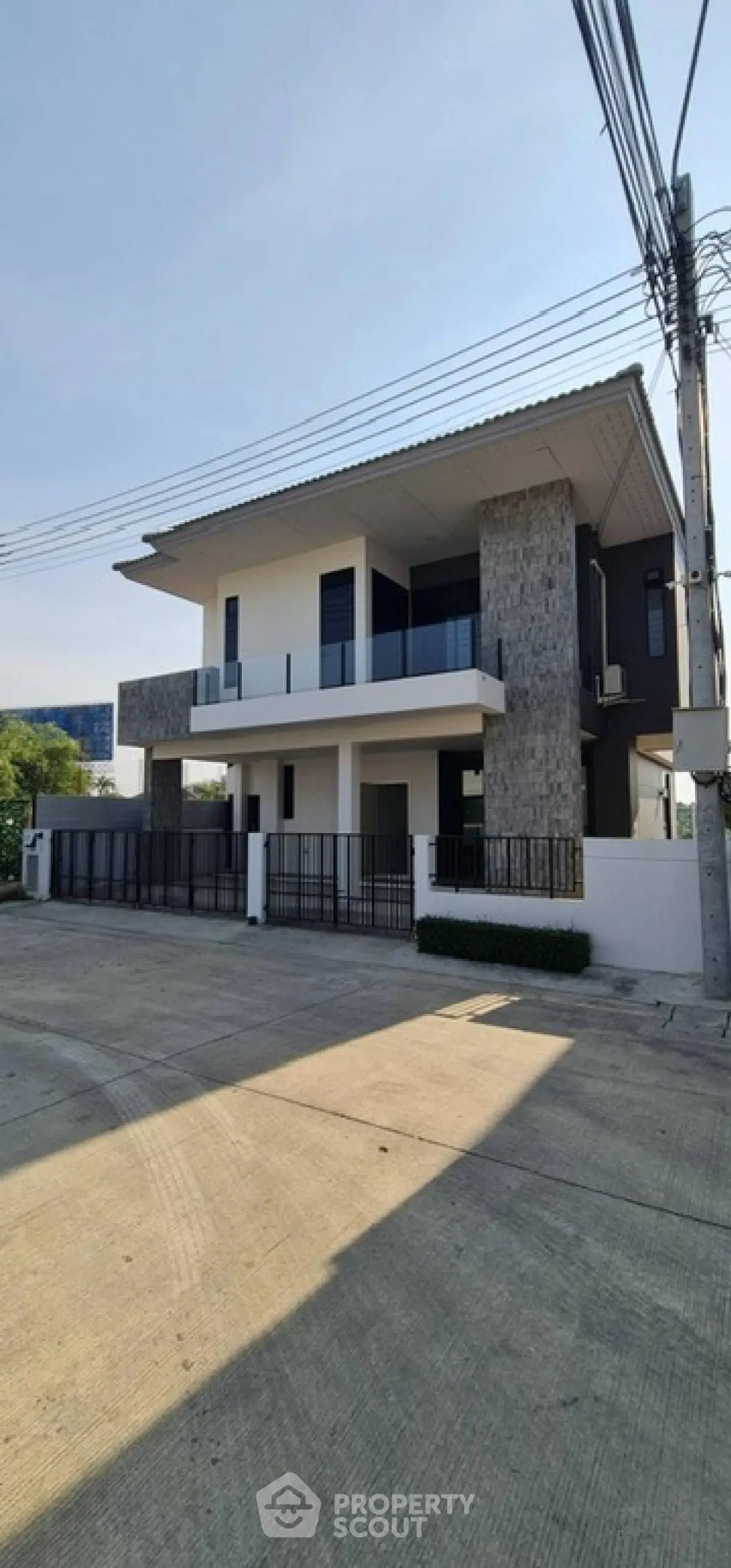 Modern two-story house with stylish facade and spacious driveway
