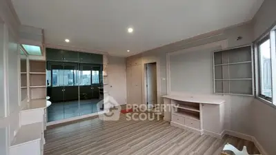 Spacious modern living room with mirrored wall and city view