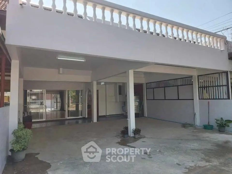 Spacious covered parking area with modern design and ample natural light.