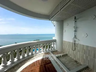 Luxurious balcony with outdoor shower and stunning ocean view, perfect for relaxation and enjoying the sea breeze.