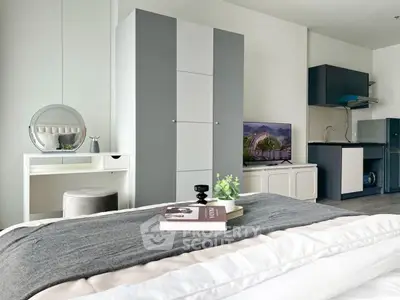 Modern studio apartment with sleek kitchen and cozy bedroom area