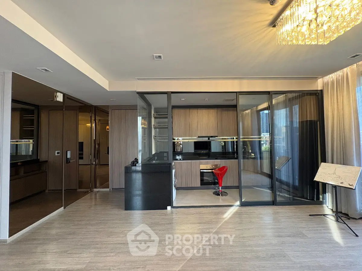 Modern living room with glass partition and elegant chandelier