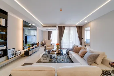 Luxurious modern living room with elegant decor and ample natural light.
