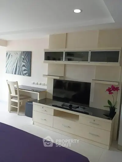 Modern living room with sleek TV unit and stylish decor in a contemporary apartment.