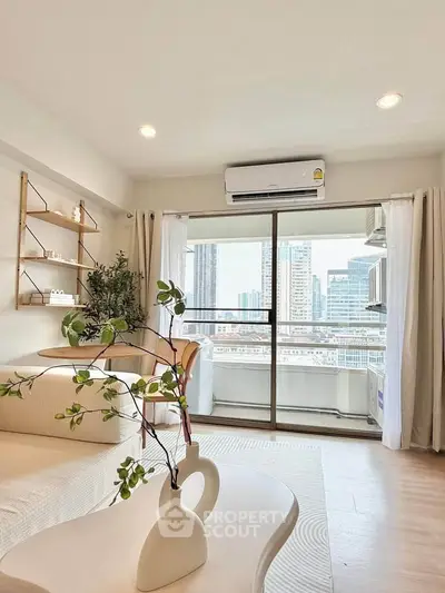 Modern living room with city view, featuring stylish decor and natural light.
