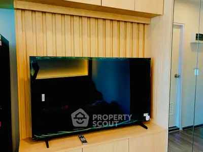 Modern living room with sleek TV and wooden paneling