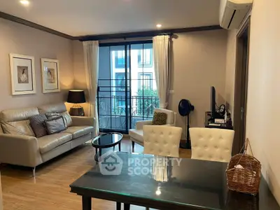 Chic living room with modern furniture and balcony view in stylish apartment