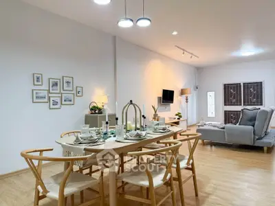 Spacious open-plan living and dining area with modern decor and elegant furniture.