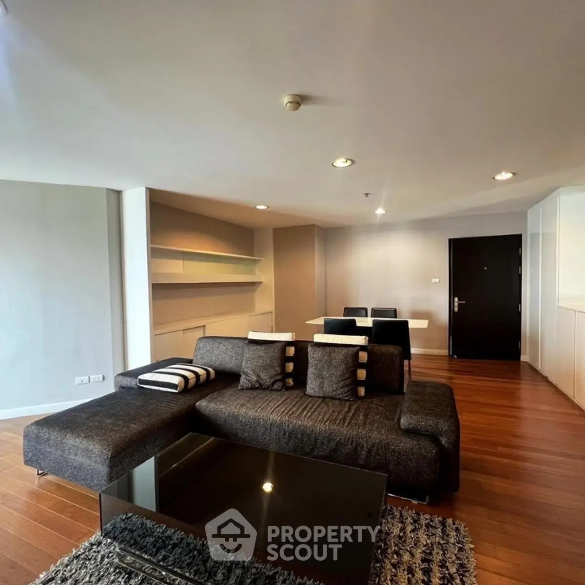 Spacious modern living room with sleek furniture and wooden flooring
