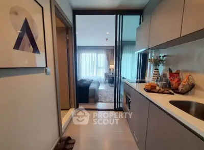 Modern apartment interior with sleek kitchen and cozy bedroom view