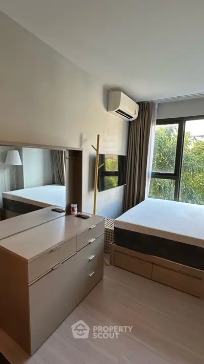 Modern bedroom with large window and stylish furniture