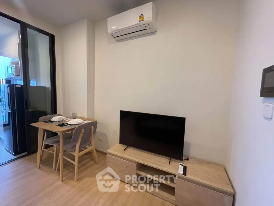 Modern living room with dining area and air conditioning in a stylish apartment.