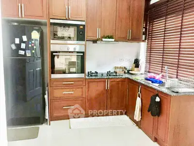 Modern kitchen with wooden cabinets and built-in appliances