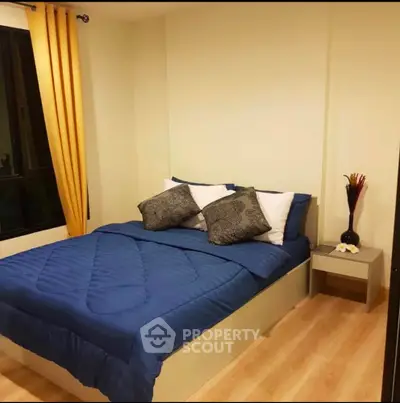 Cozy bedroom with blue bedding and modern decor in a stylish apartment