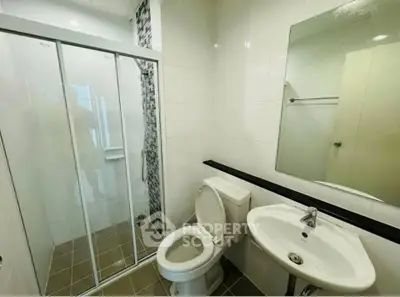 Modern bathroom with glass shower enclosure and sleek fixtures