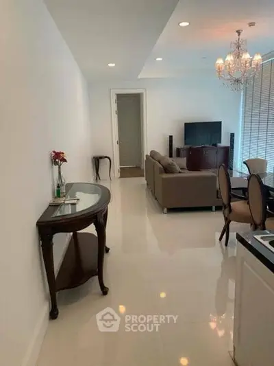 Elegant living room with chandelier and modern furniture in a spacious apartment.