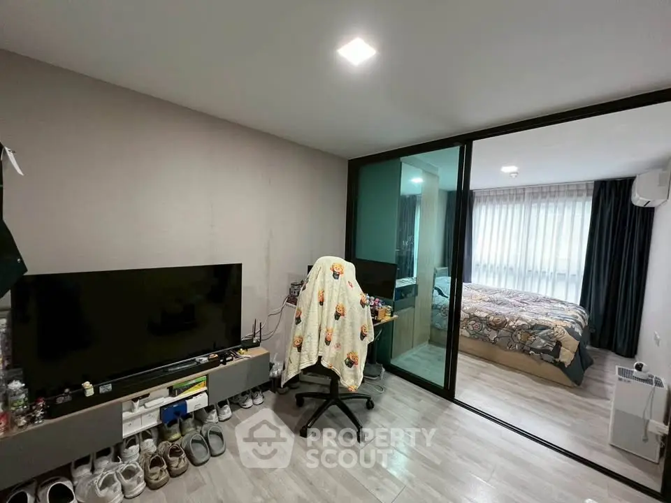 Modern bedroom with glass partition and cozy workspace