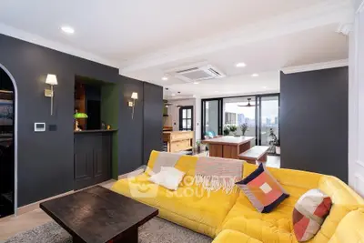 Stylish living room with vibrant yellow sofa and modern open layout