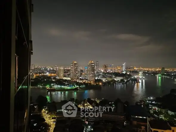 Stunning night view of city skyline and river from high-rise balcony